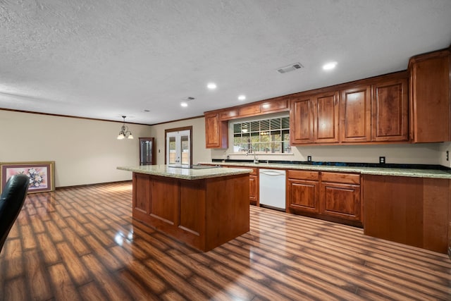 kitchen featuring dark hardwood / wood-style flooring, ornamental molding, pendant lighting, a chandelier, and a kitchen island