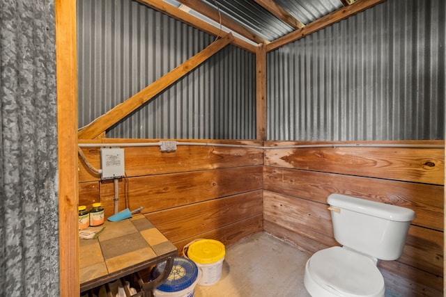 bathroom featuring concrete flooring and toilet