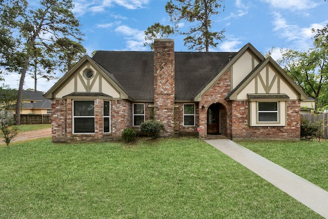 tudor home featuring a front lawn