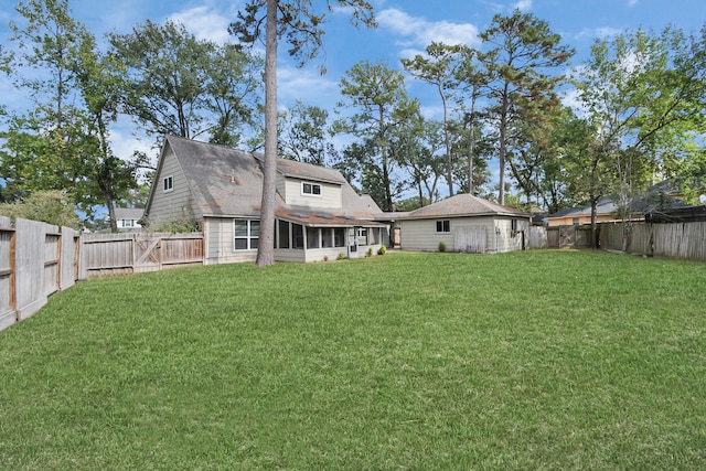 back of house with a lawn and a sunroom