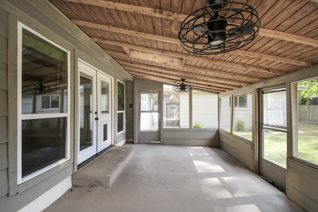 unfurnished sunroom with vaulted ceiling with beams, plenty of natural light, and wood ceiling