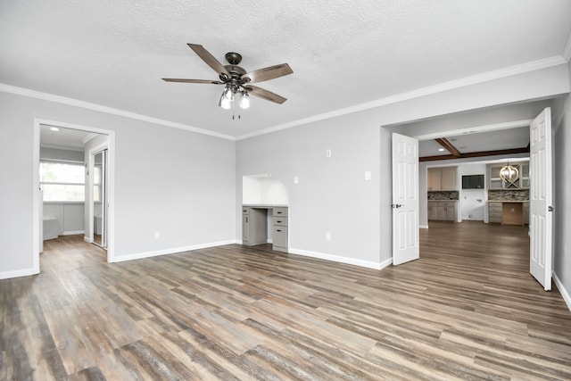 unfurnished living room featuring wood-type flooring, a textured ceiling, ceiling fan, and crown molding