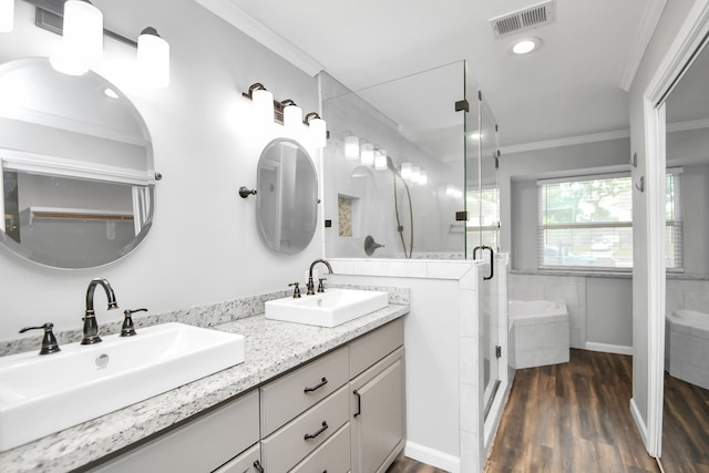 bathroom with vanity, ornamental molding, an enclosed shower, and hardwood / wood-style flooring