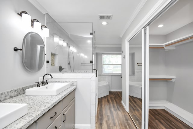 bathroom featuring a shower with shower door, wood-type flooring, crown molding, and vanity