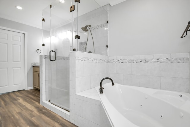 bathroom featuring hardwood / wood-style floors, vanity, shower with separate bathtub, and ornamental molding