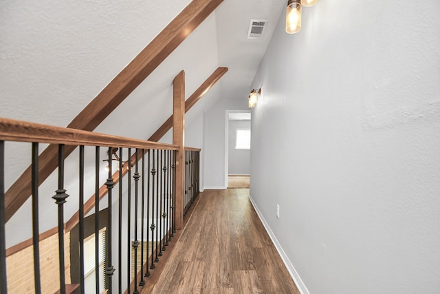 hallway featuring dark hardwood / wood-style floors and lofted ceiling