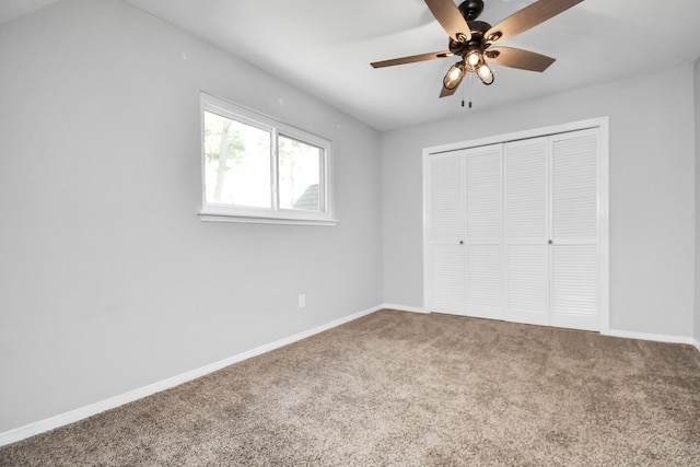 unfurnished bedroom featuring ceiling fan, a closet, and carpet