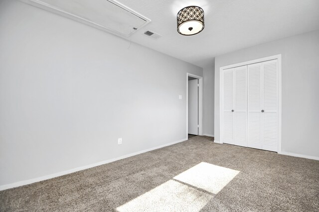 unfurnished bedroom with a closet and carpet