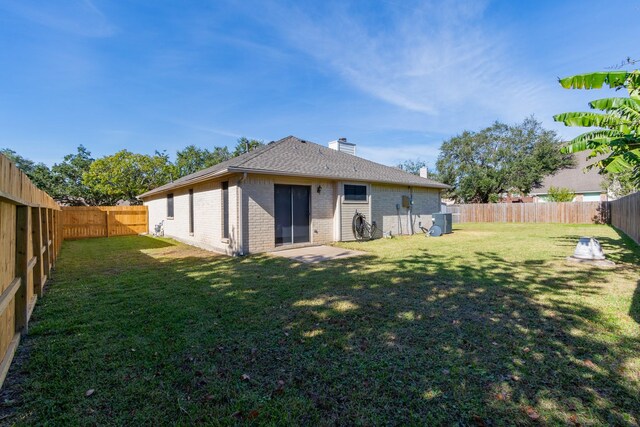 16418 Red Oak Dr, Missouri City, TX 77489 - back of house featuring a yard and central AC