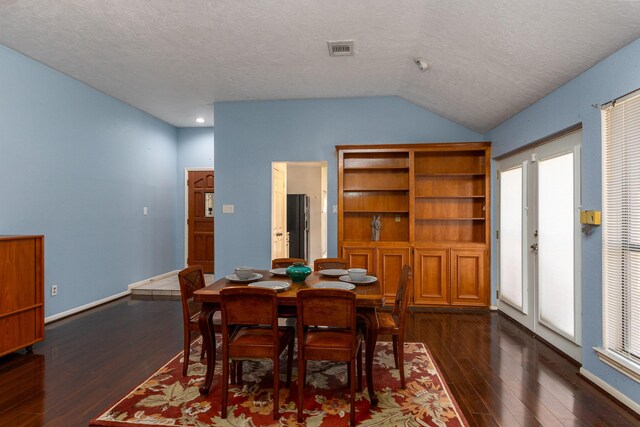 16418 Red Oak Dr, Missouri City, TX 77489 - dining room featuring a textured ceiling, dark hardwood / wood-style floors, and lofted ceiling