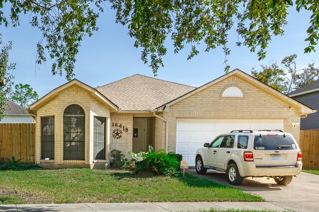 ranch-style home featuring a front yard and a garage