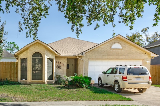 single story home with a garage and a front yard