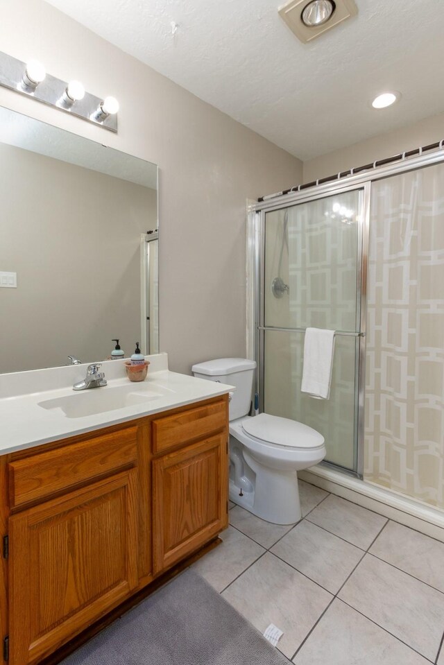 16418 Red Oak Dr, Missouri City, TX 77489 - bathroom featuring vanity, toilet, tile patterned floors, and an enclosed shower