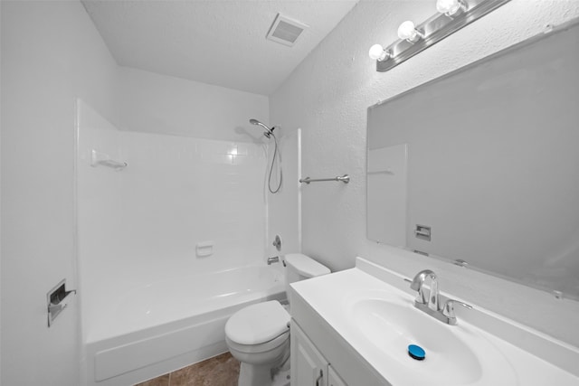 full bathroom with shower / bath combination, vanity, a textured ceiling, tile patterned flooring, and toilet