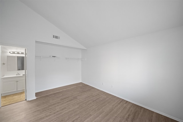 bonus room featuring high vaulted ceiling and wood-type flooring