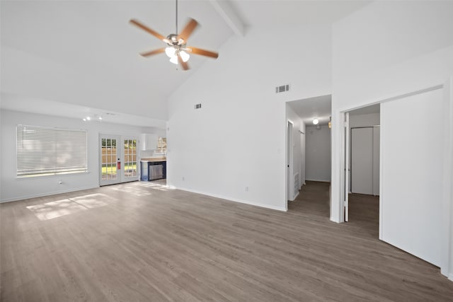 unfurnished living room with ceiling fan, french doors, beamed ceiling, high vaulted ceiling, and dark hardwood / wood-style floors