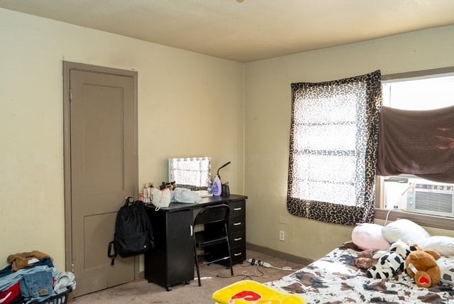 bedroom featuring light carpet and cooling unit