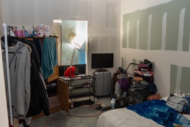 bedroom featuring concrete floors