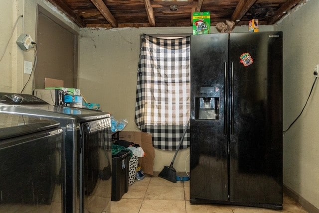 washroom with light tile patterned flooring and washing machine and clothes dryer