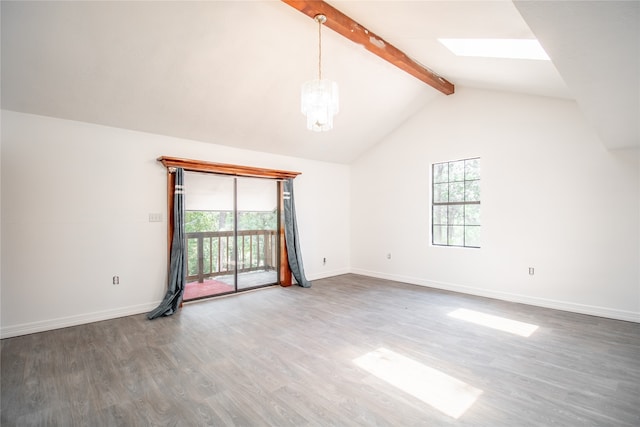 spare room with wood-type flooring and lofted ceiling with skylight