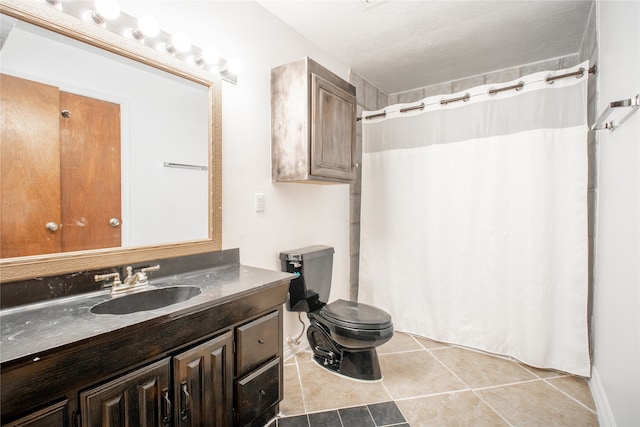 bathroom featuring tile patterned flooring, vanity, and toilet