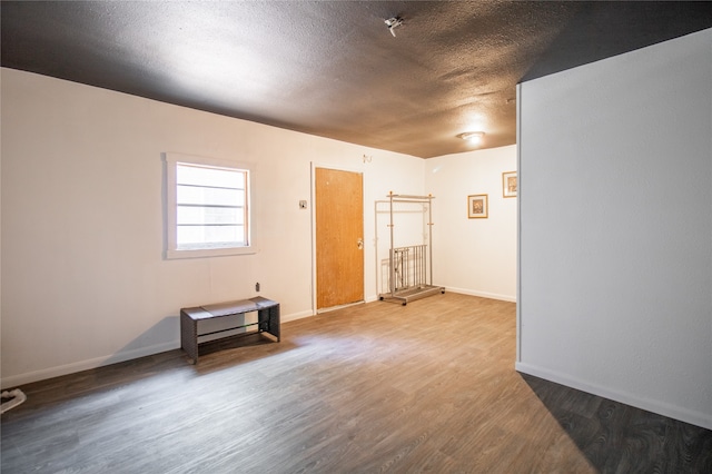 spare room with hardwood / wood-style floors and a textured ceiling