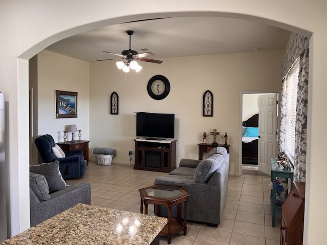 tiled living room featuring ceiling fan