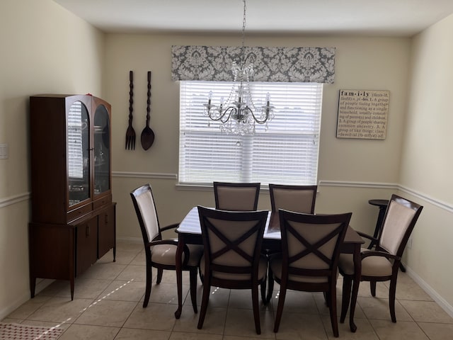 tiled dining area featuring an inviting chandelier