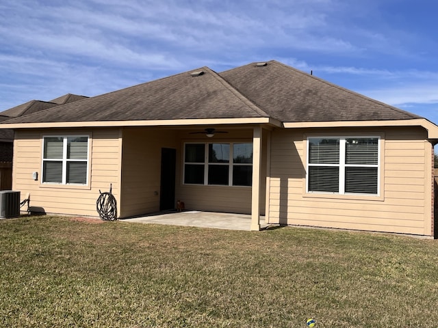 rear view of house with a patio, ceiling fan, cooling unit, and a lawn