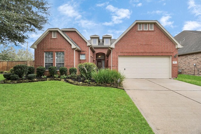 view of property with a front yard and a garage