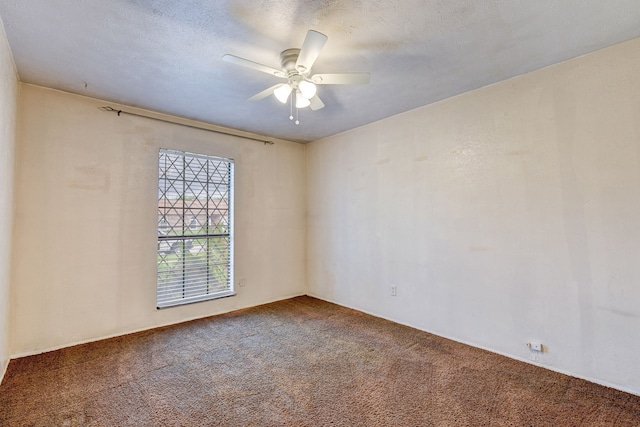 spare room featuring carpet, a textured ceiling, and ceiling fan