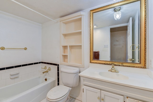 bathroom with a bathtub, toilet, a textured ceiling, and vanity