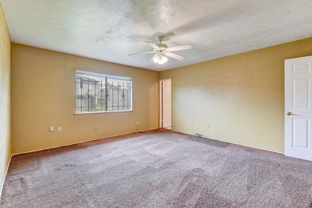 unfurnished room featuring ceiling fan, carpet, and a textured ceiling