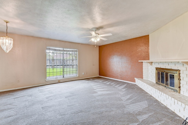 unfurnished living room with carpet, a textured ceiling, and a brick fireplace