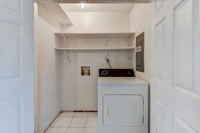 laundry room with electric panel, light tile patterned flooring, and washer / dryer