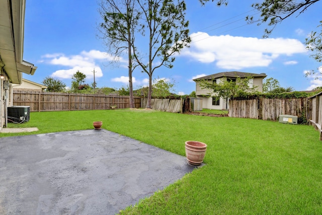 view of yard with central AC unit and a patio area