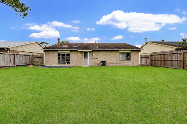 back of house featuring cooling unit and a yard