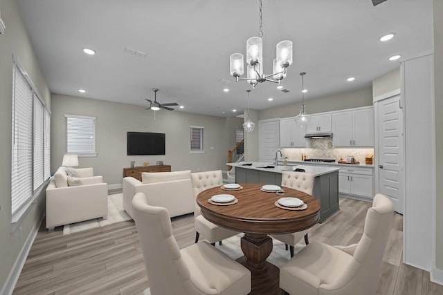 16034 Mason Run Dr, Houston, TX 77079 - dining area with a ceiling fan, light wood finished floors, a chandelier, and recessed lighting