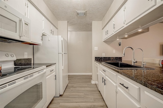 kitchen with sink, white cabinetry, a textured ceiling, light hardwood / wood-style flooring, and white appliances