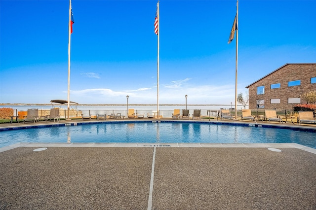 view of pool featuring a water view