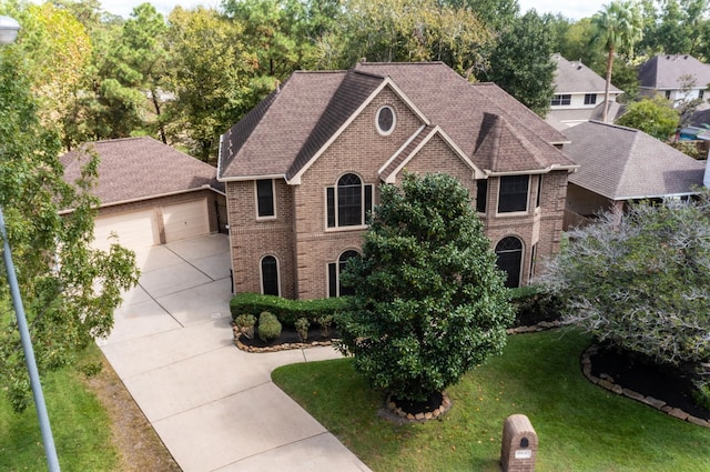 view of front of property featuring a garage and a front lawn