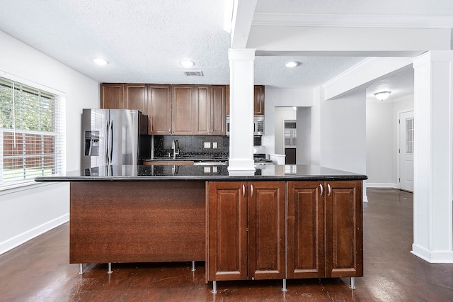 kitchen with a center island, sink, a textured ceiling, and appliances with stainless steel finishes