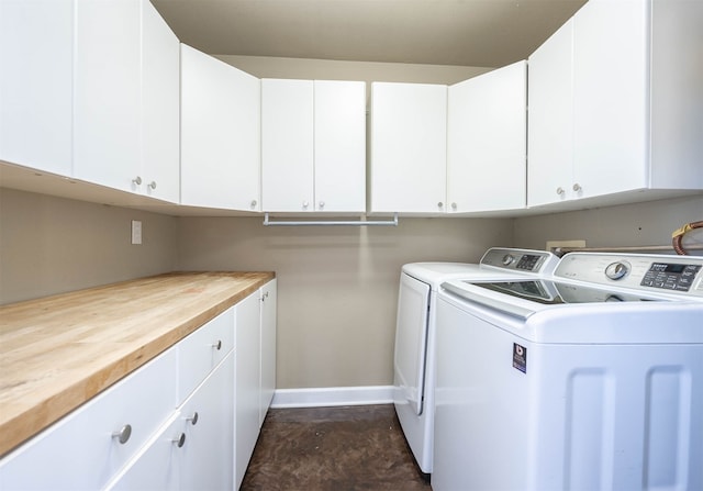 laundry room featuring cabinets and washer and clothes dryer