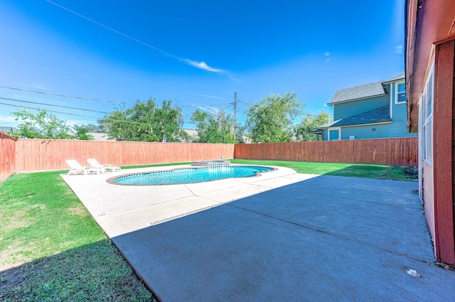 view of pool with a patio area and a lawn