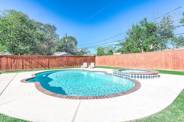 view of swimming pool featuring an in ground hot tub and a patio