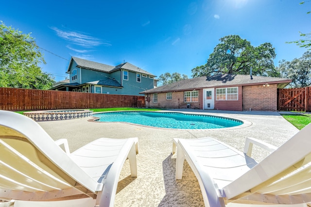 view of swimming pool featuring an in ground hot tub and a patio