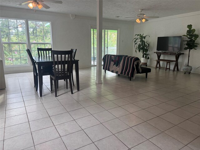 dining area with light tile patterned floors, ceiling fan, and a healthy amount of sunlight