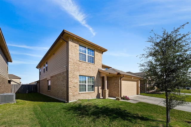 view of front of house with cooling unit, a garage, and a front lawn