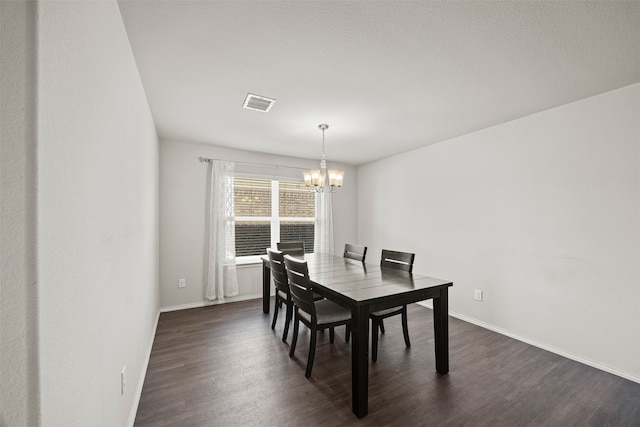 dining room featuring a chandelier and dark hardwood / wood-style floors