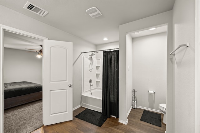 bathroom featuring wood-type flooring, shower / tub combo, toilet, and ceiling fan